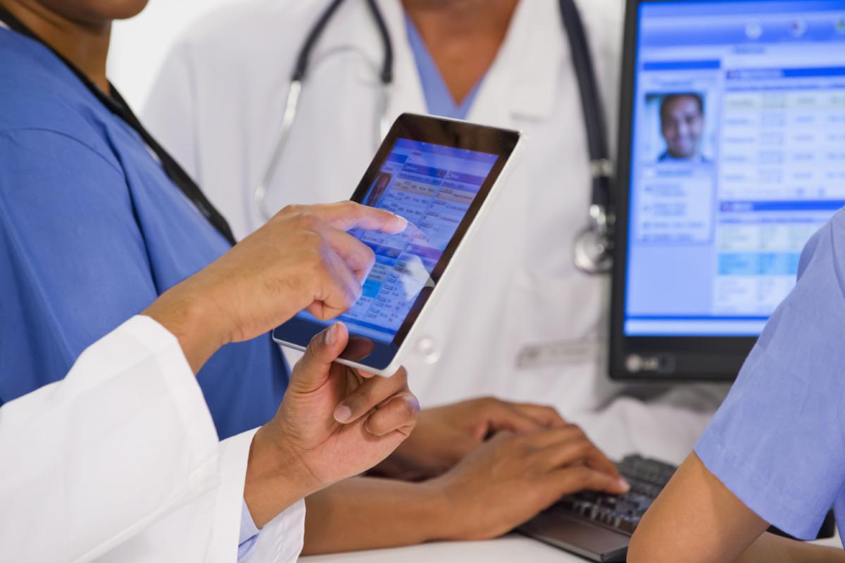 Medical professional touches tablet