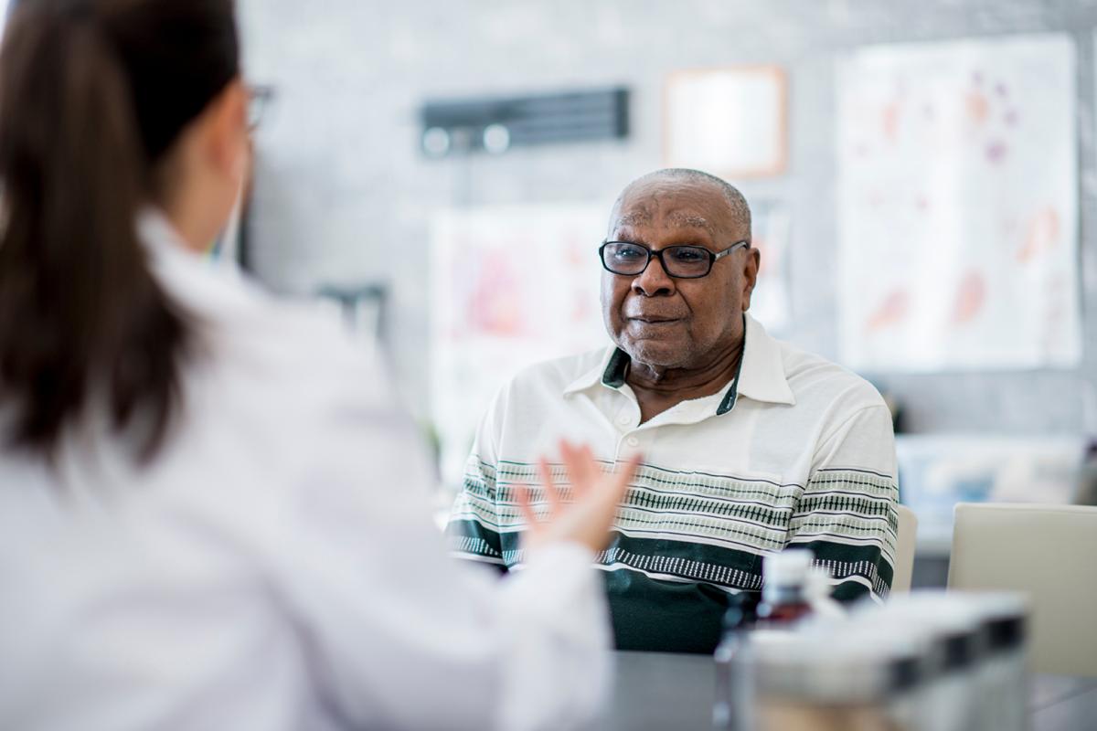 Doctor talking to elderly man