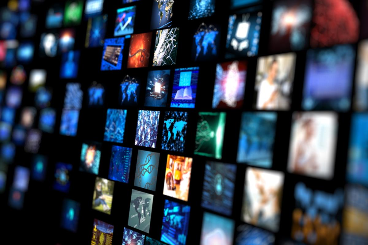 Wall of television monitors aglow with media broadcasting