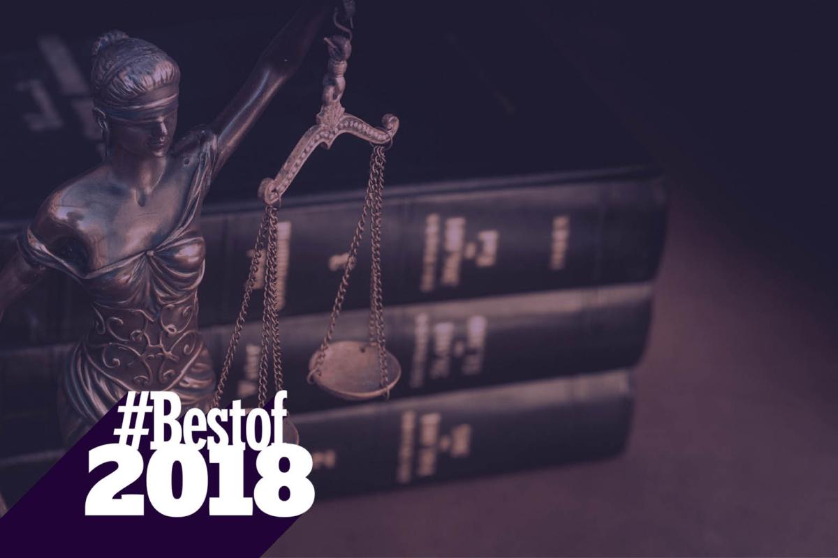 Scales of justice in front of a stack of law books