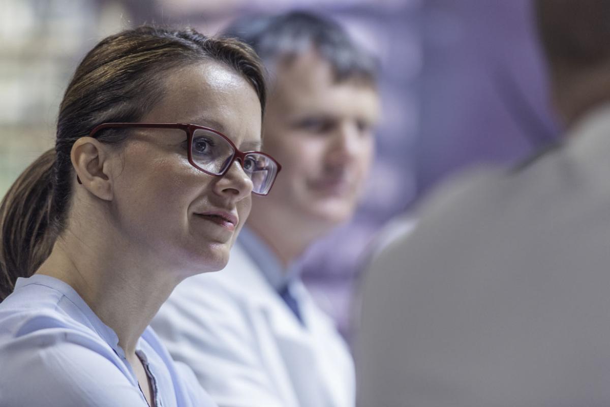 Two physicians listening during a group conversation
