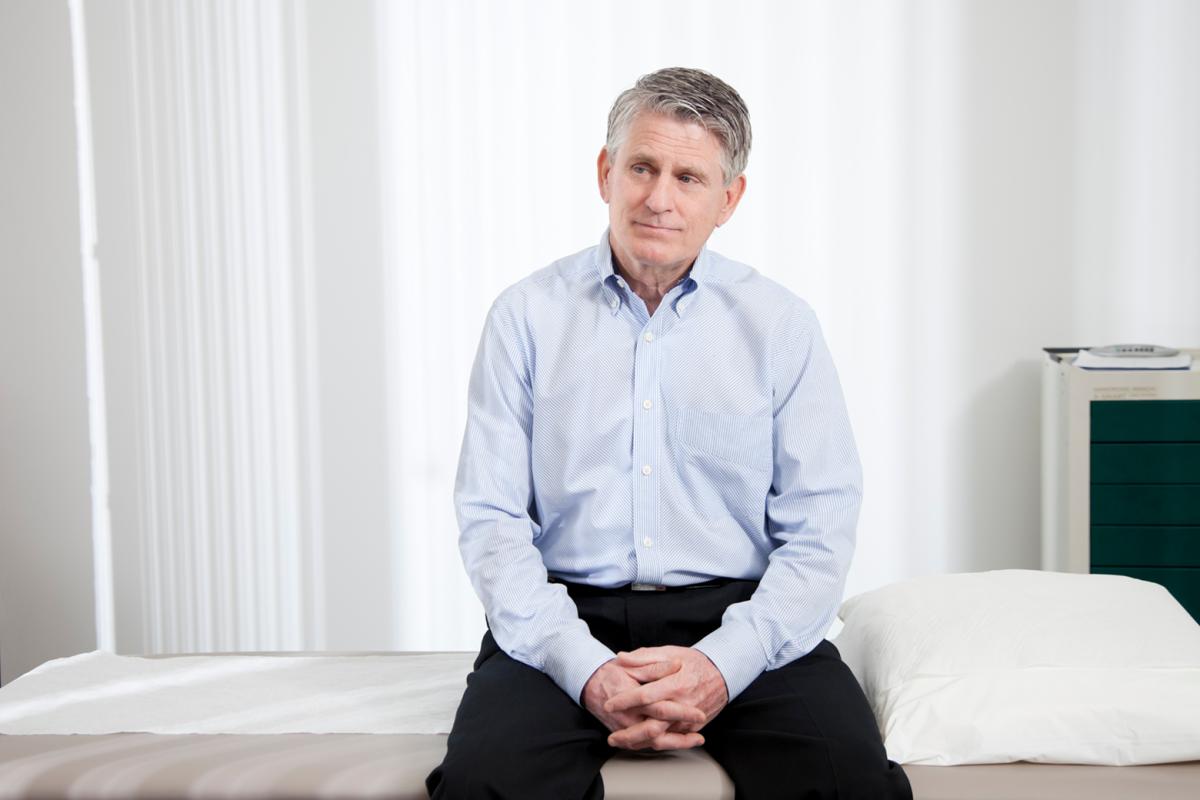 A man sitting on a bed