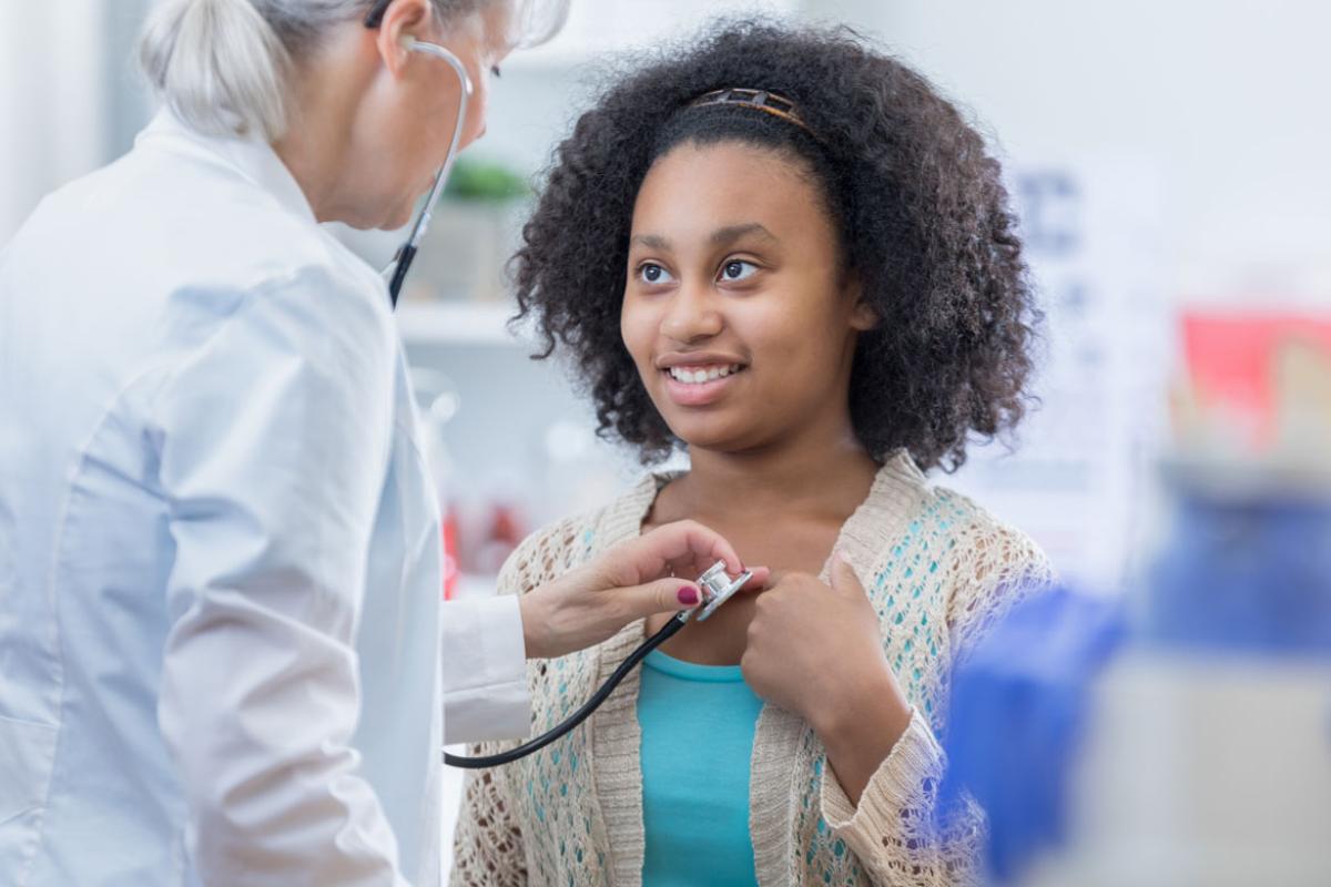 Physician attending to a girl patient