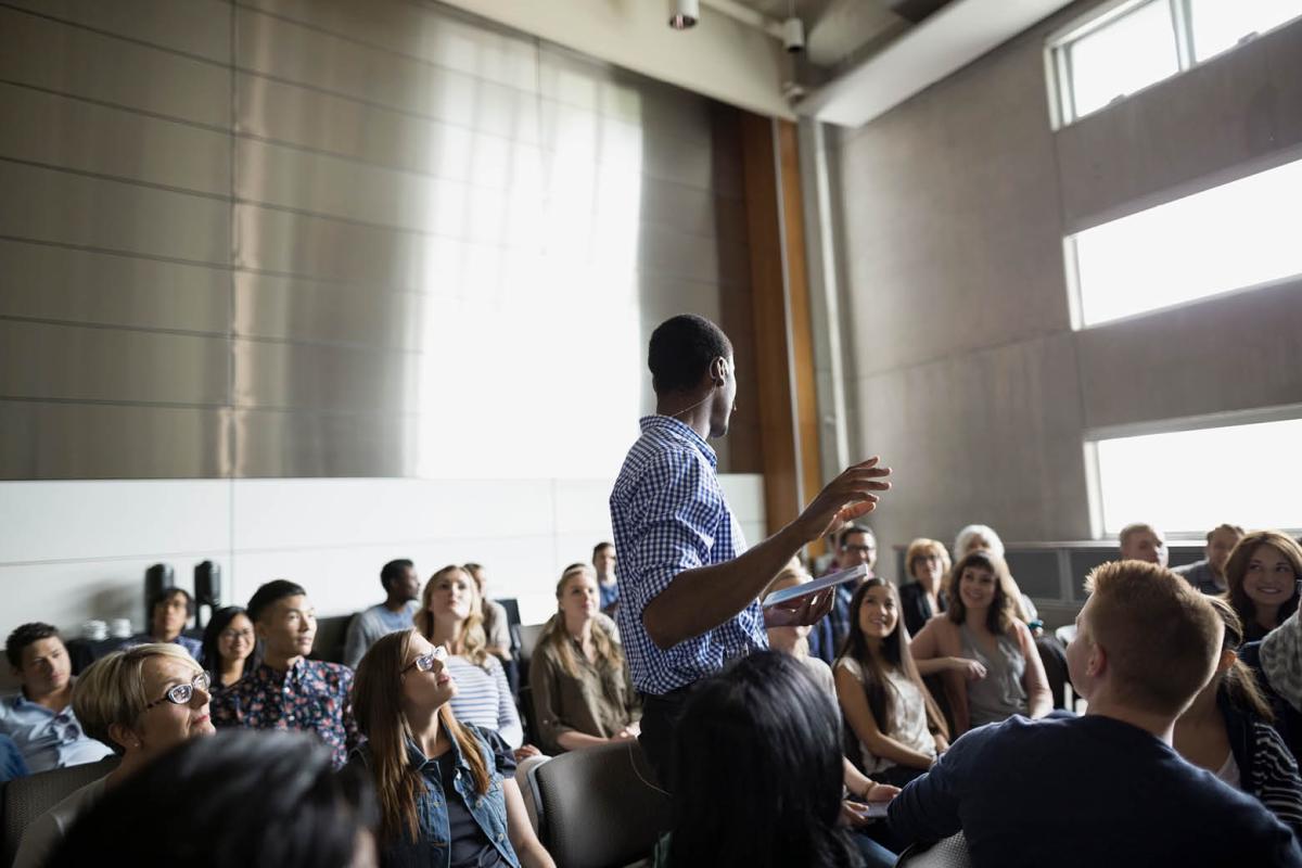 Young adult speaking to a large group