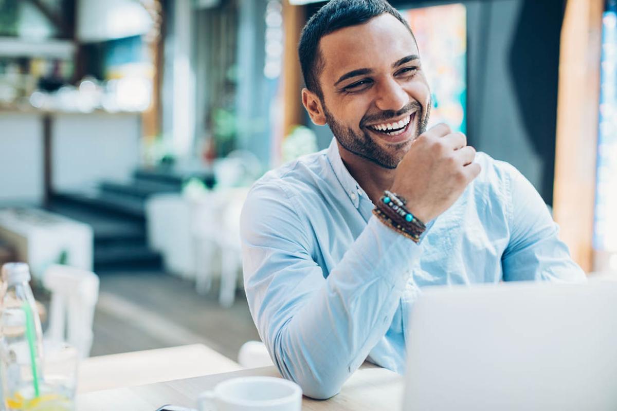 Laughing man sitting in a cafe