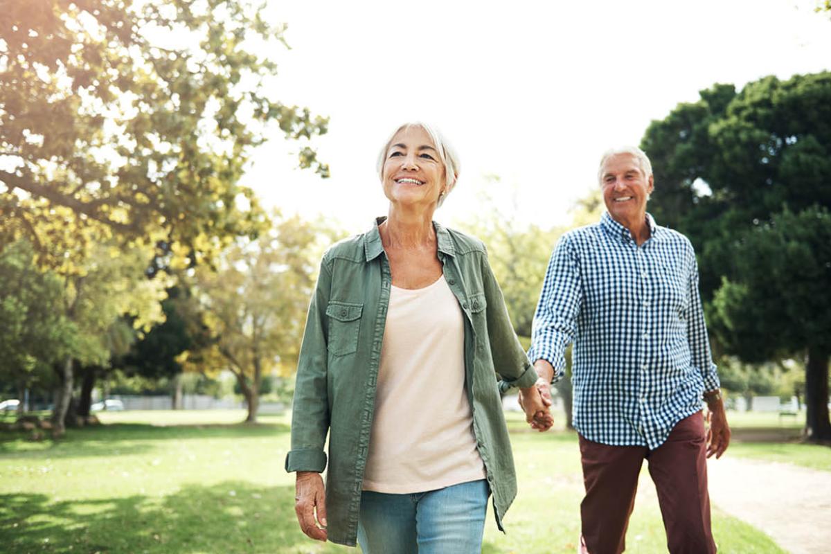 Couple walking through a park