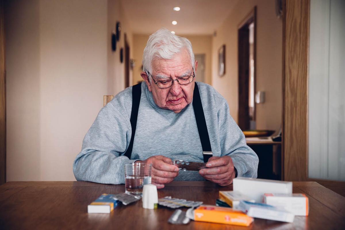 Man looking at his medication