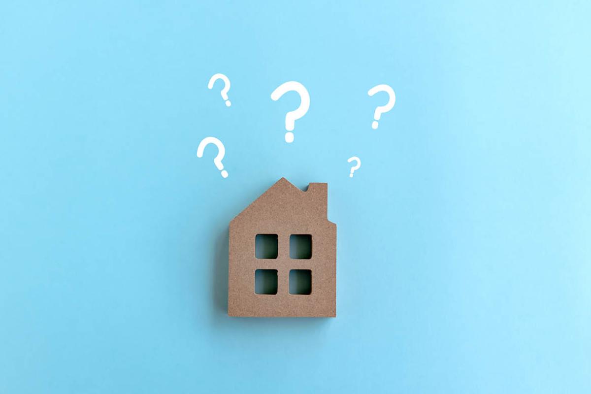 Image of a building surrounded by question marks