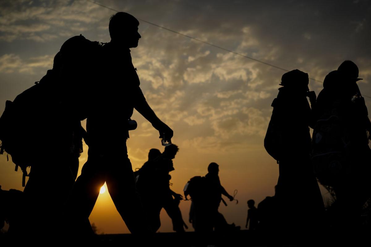 Silhouettes of people walking
