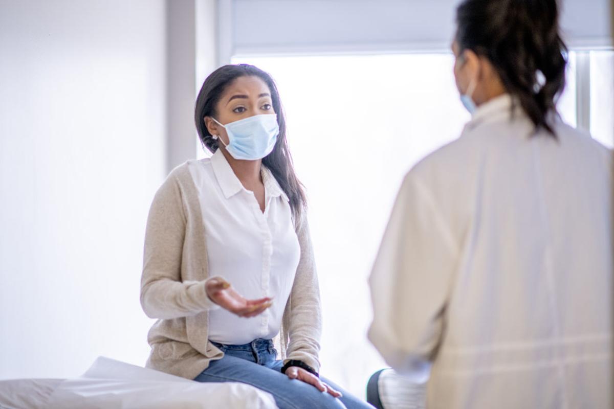 Physician and patient wearing face masks