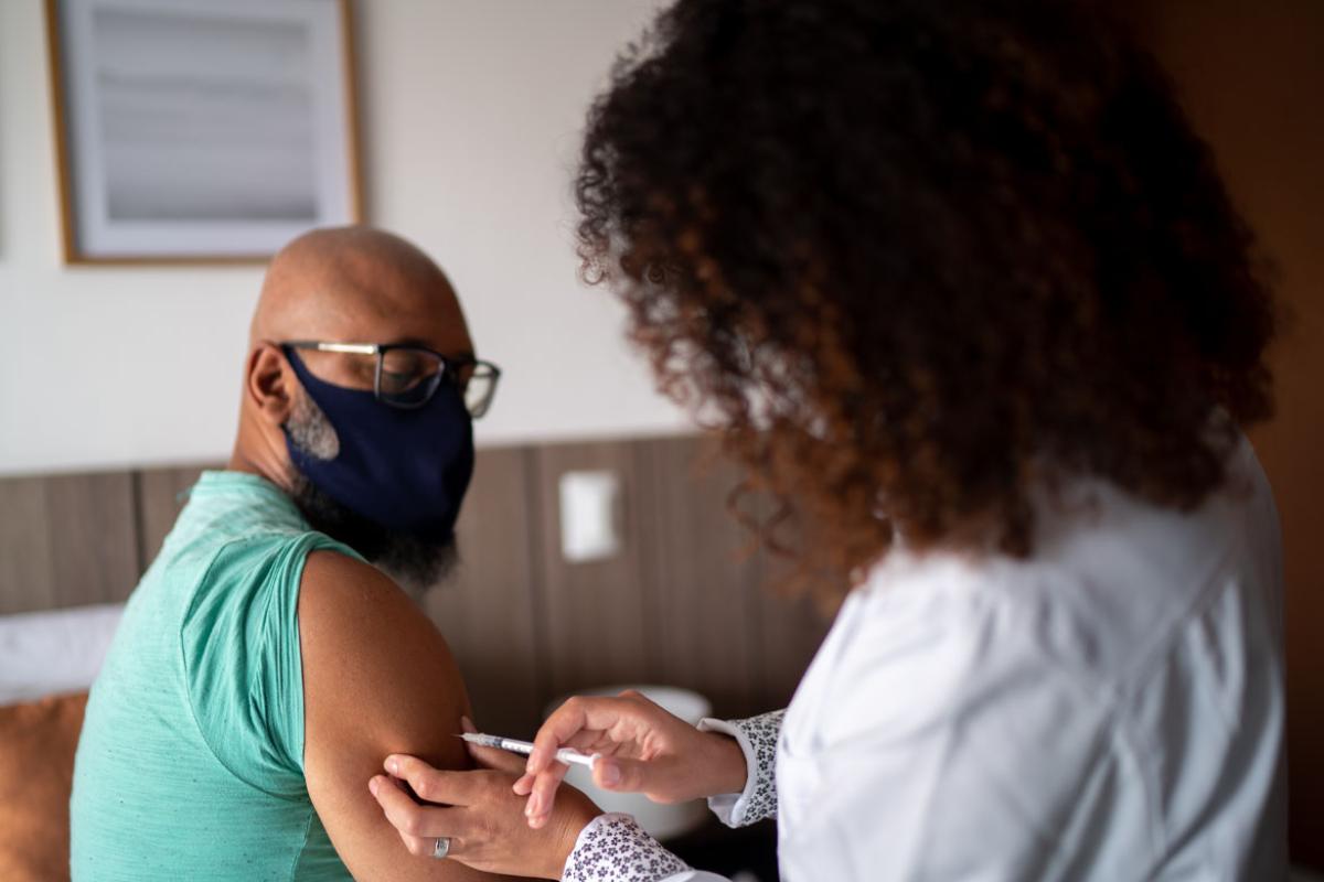 Person receiving a vaccine.