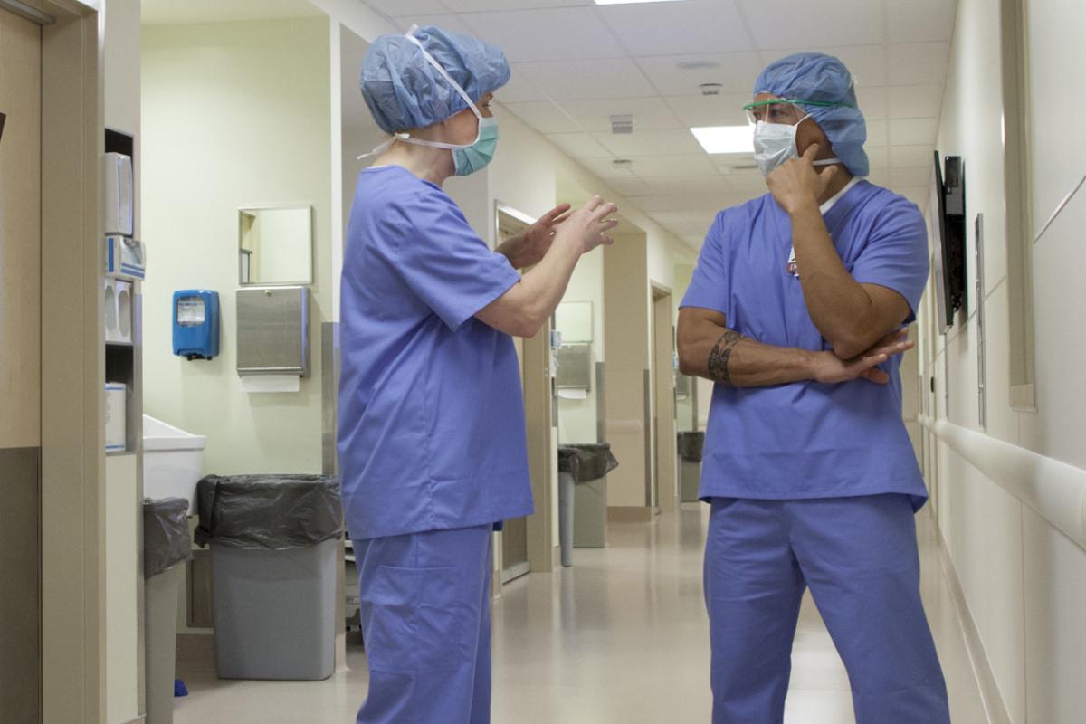 Two health care workers speaking