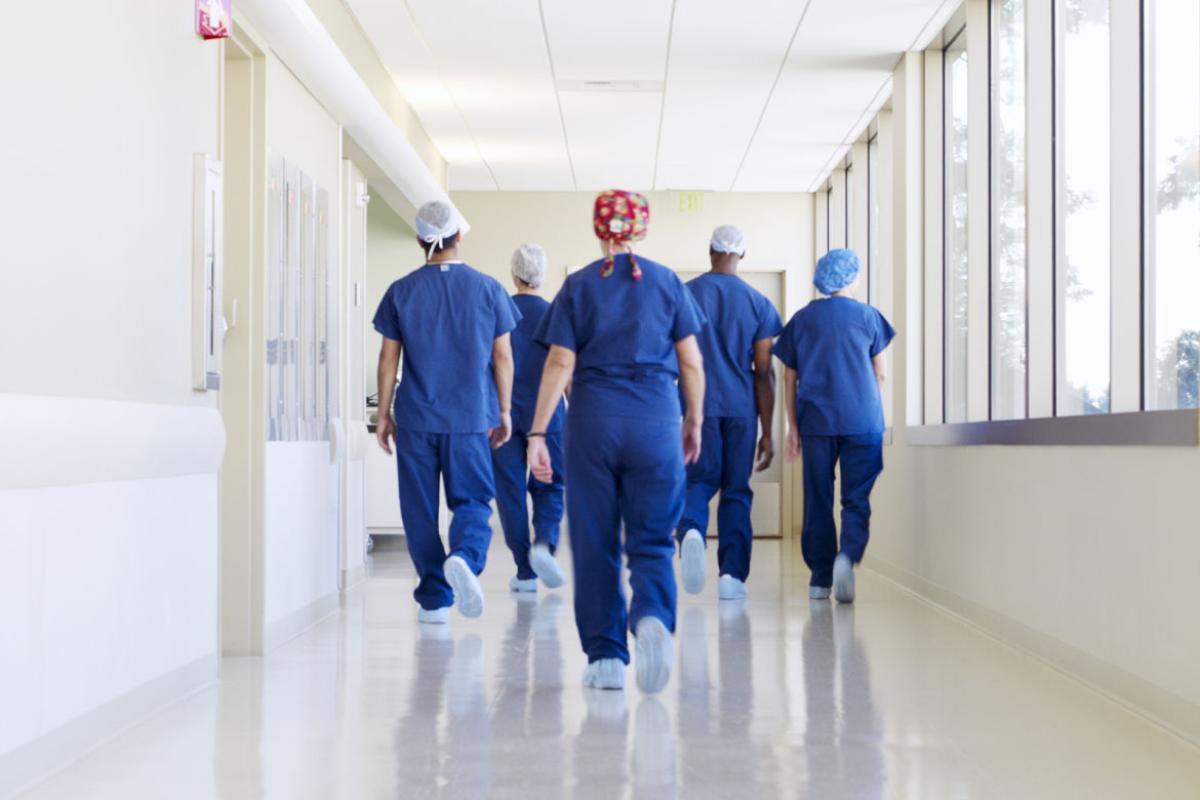 Health care workers walking down a hallway