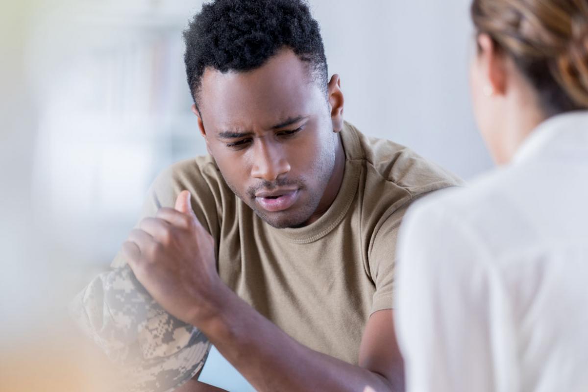 Military veteran speaking with another individual