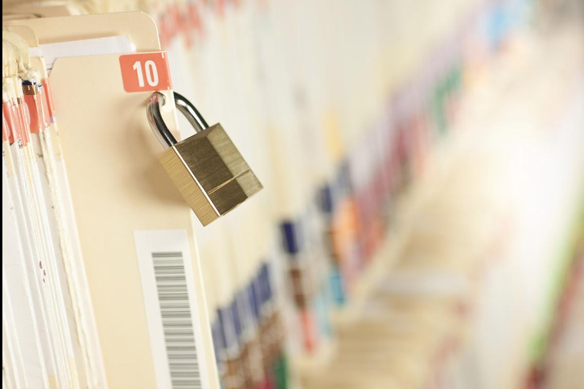 A lock placed on a medical file and folder for security