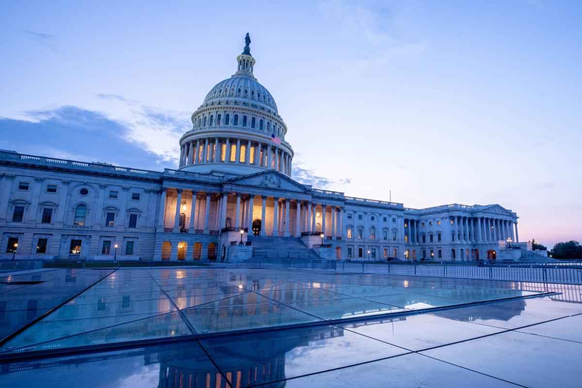 Wide shot of Capitol building and plaza at dawn
