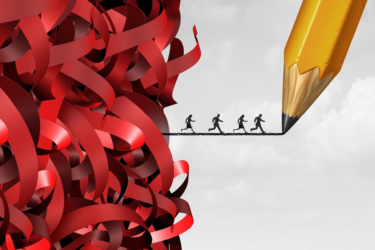 A group of people running across a graphite powder line placed between a cascade of ribbons and a pencil tip