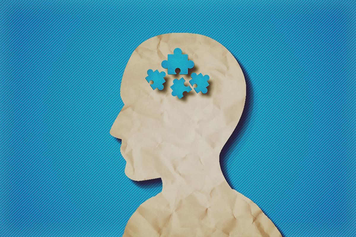Profile of a paper head with puzzle pieces