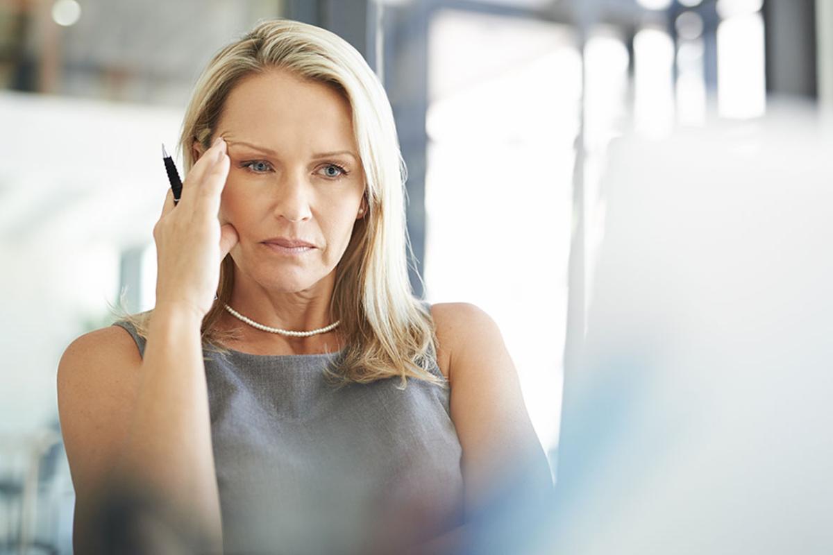 Person sitting with head in hand