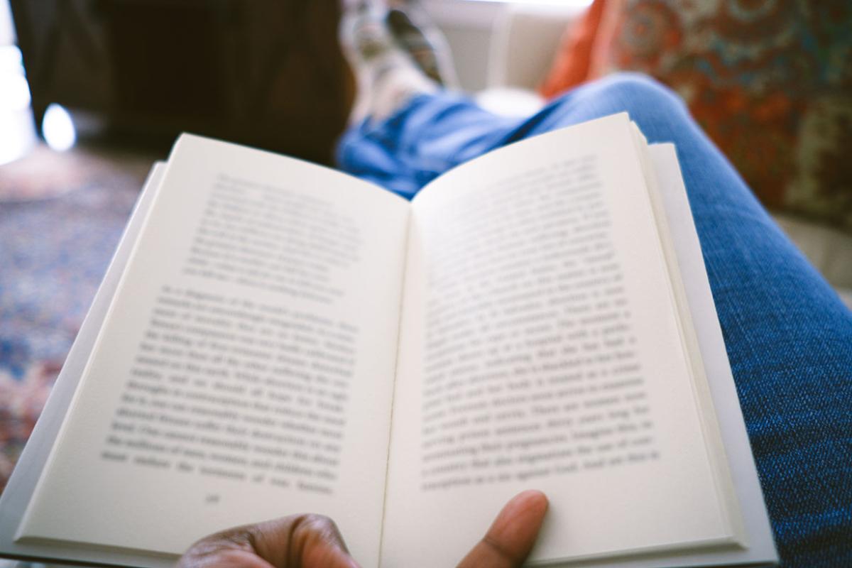 Hand holding an open book