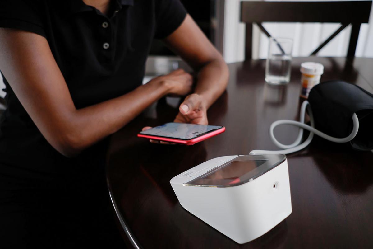 Person using smartphone for self-measured blood pressure