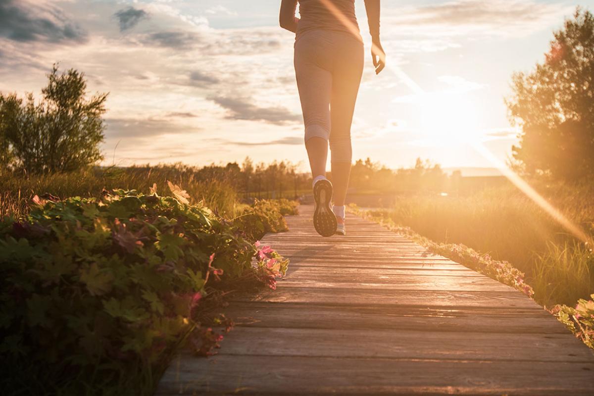Person running in a park at sunset