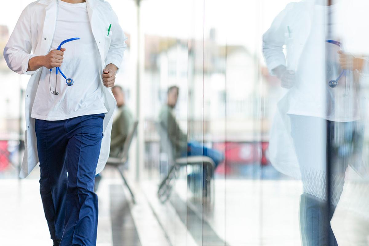Medical professional running down a corridor