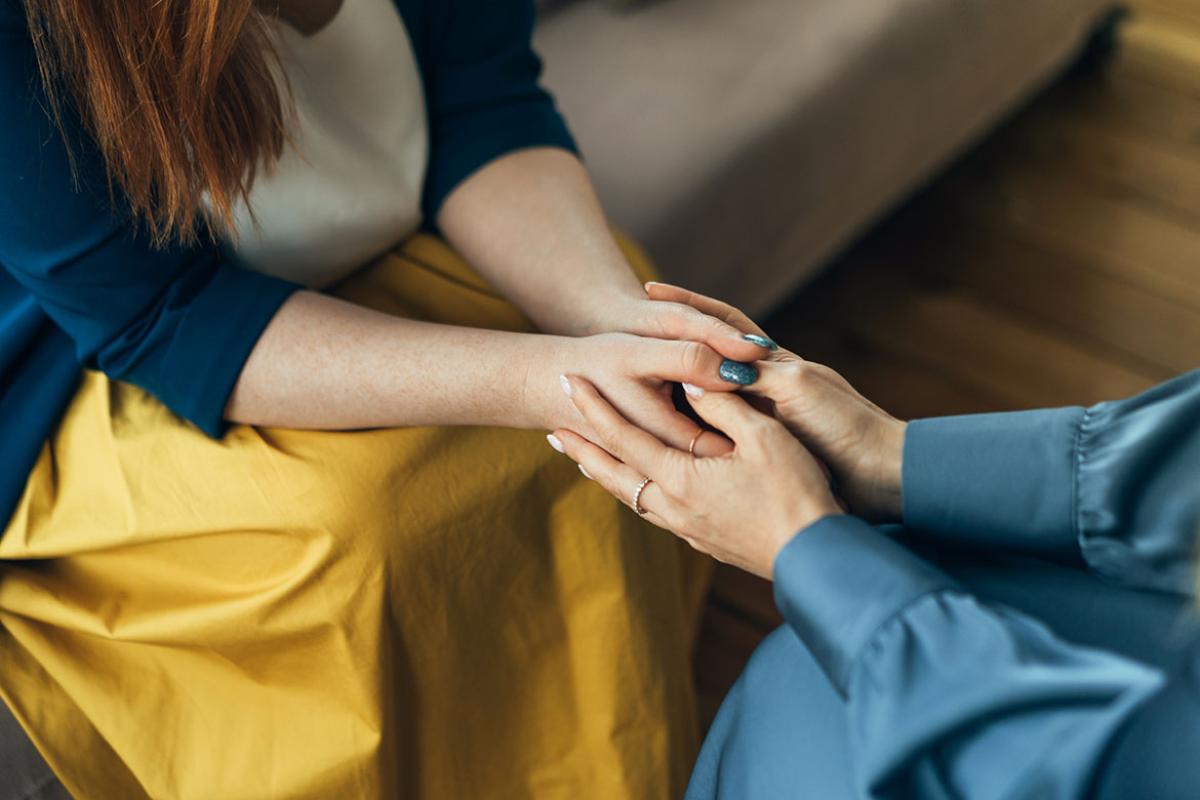 Two people holding hands