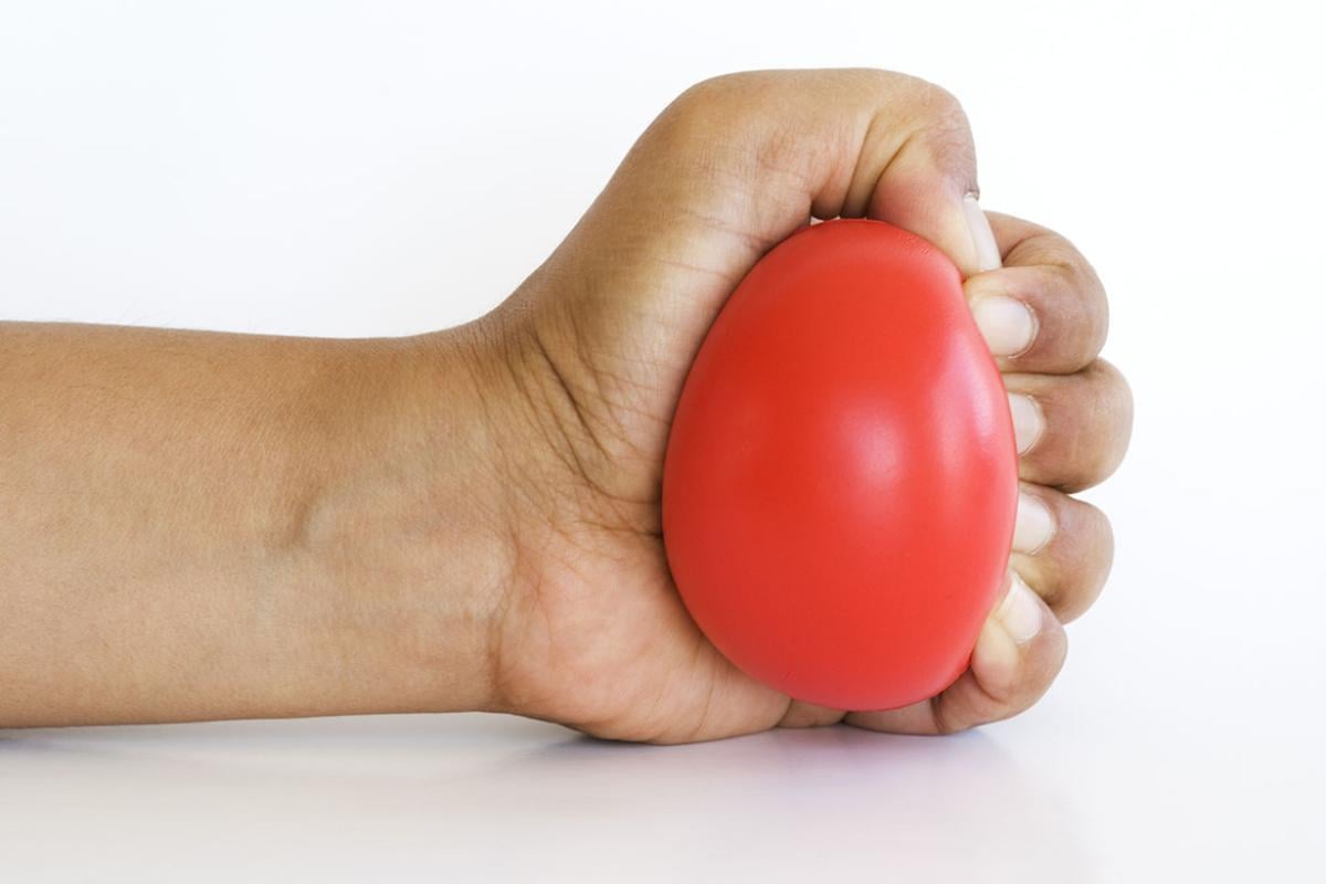 Hand clenching a stress ball