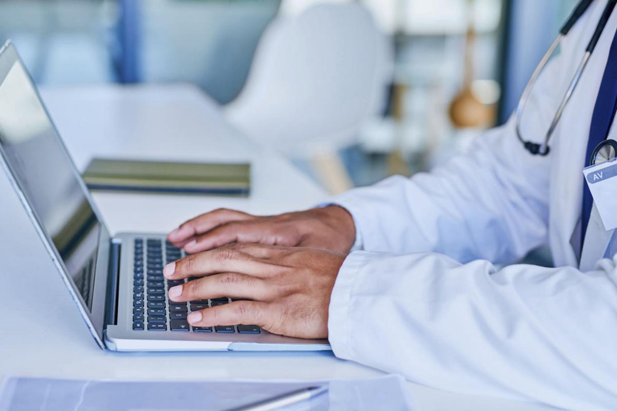 Doctor using a laptop at work