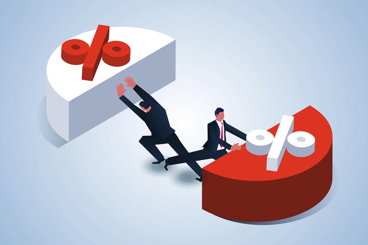  Two businessmen pushing away an average sized pie chart