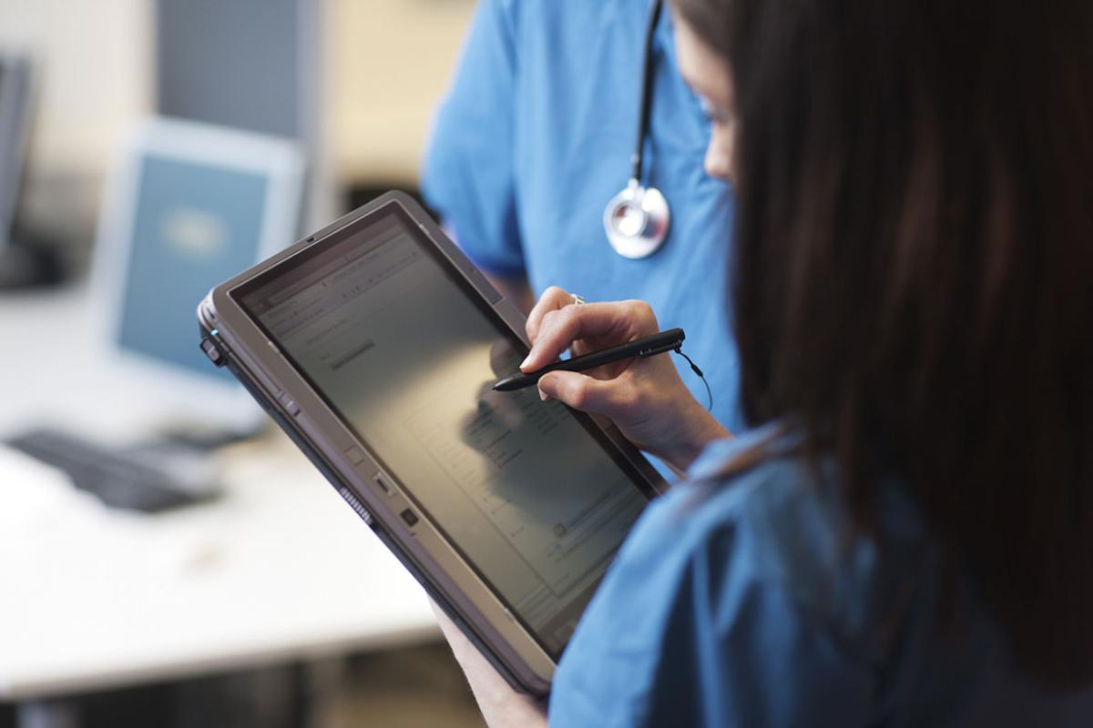 Health care worker uses handheld device