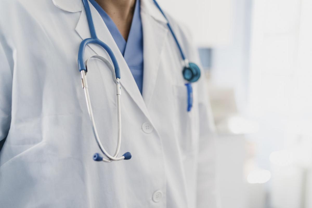 Physician wearing a stethoscope