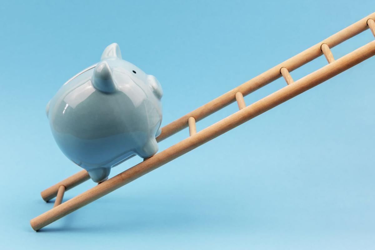Piggy bank on a ladder