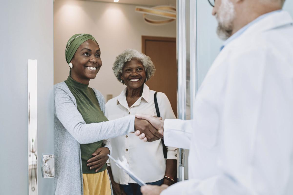 Doctor welcomes patients with a handshake