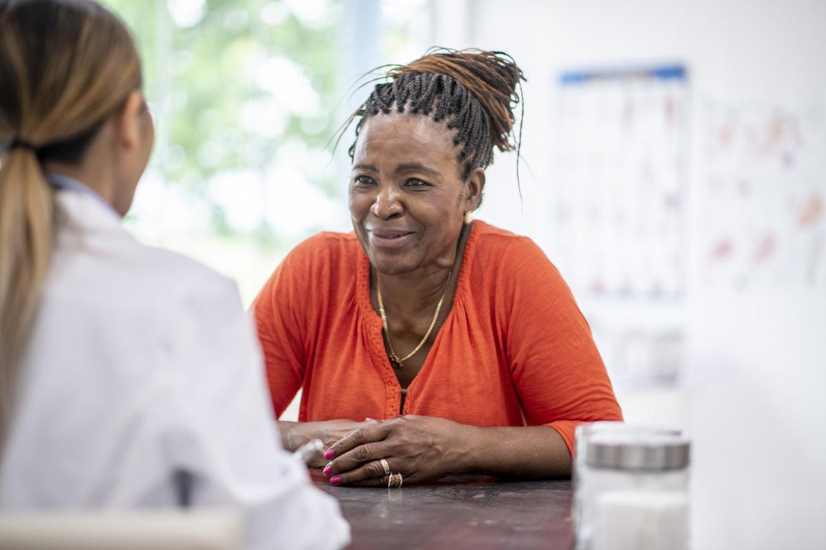 Smiling patient sits across from doctor