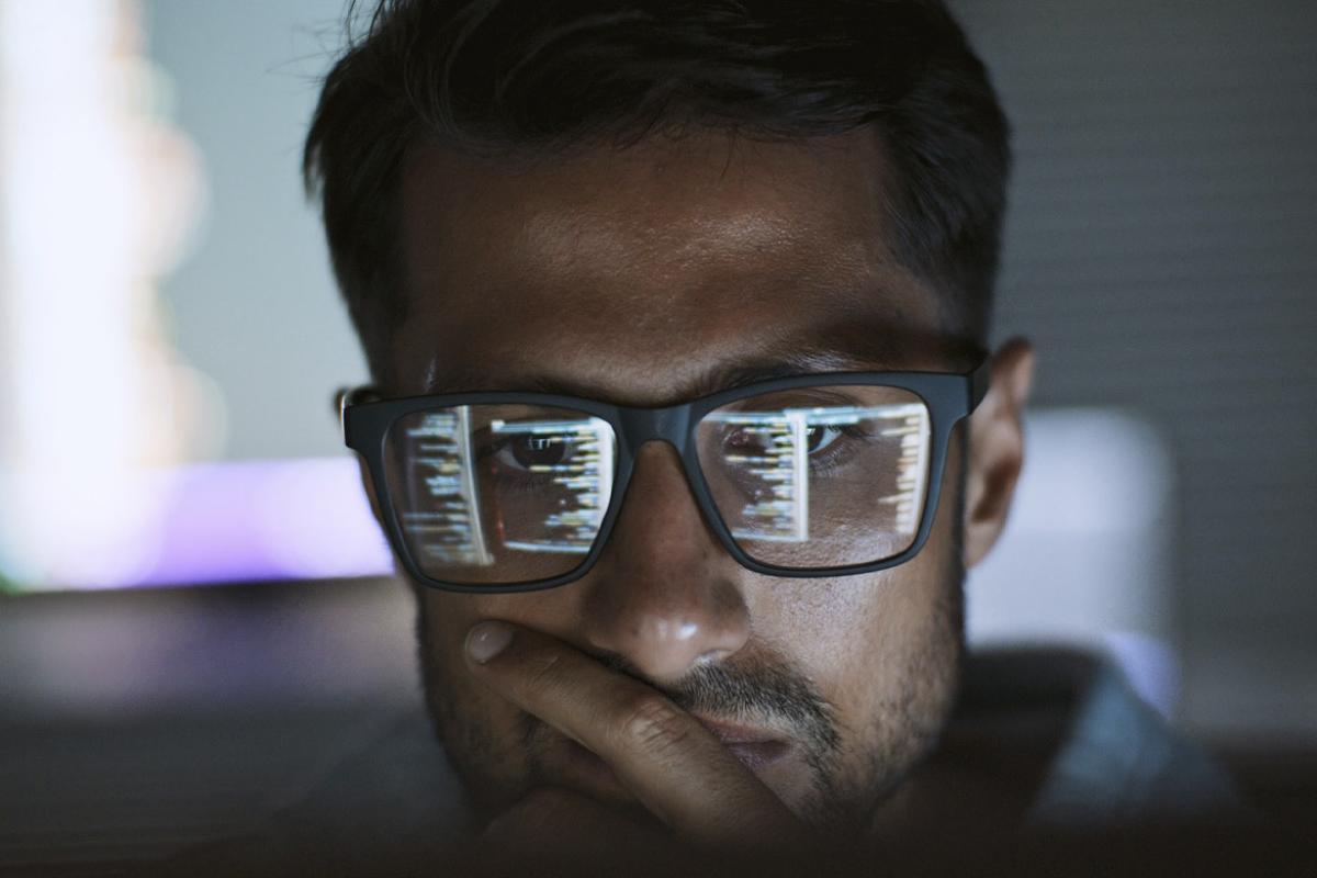 Computer screen reflected in a person's glasses