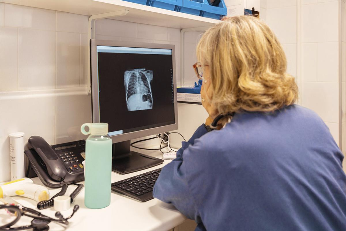 Health worker reviews X-rays
