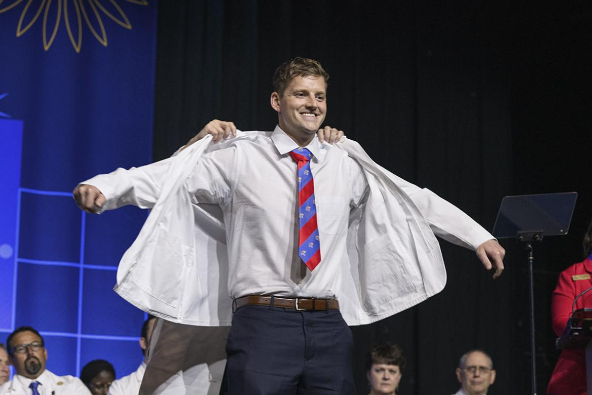 University of Kansas medical student Paul Kueck dons his white coat