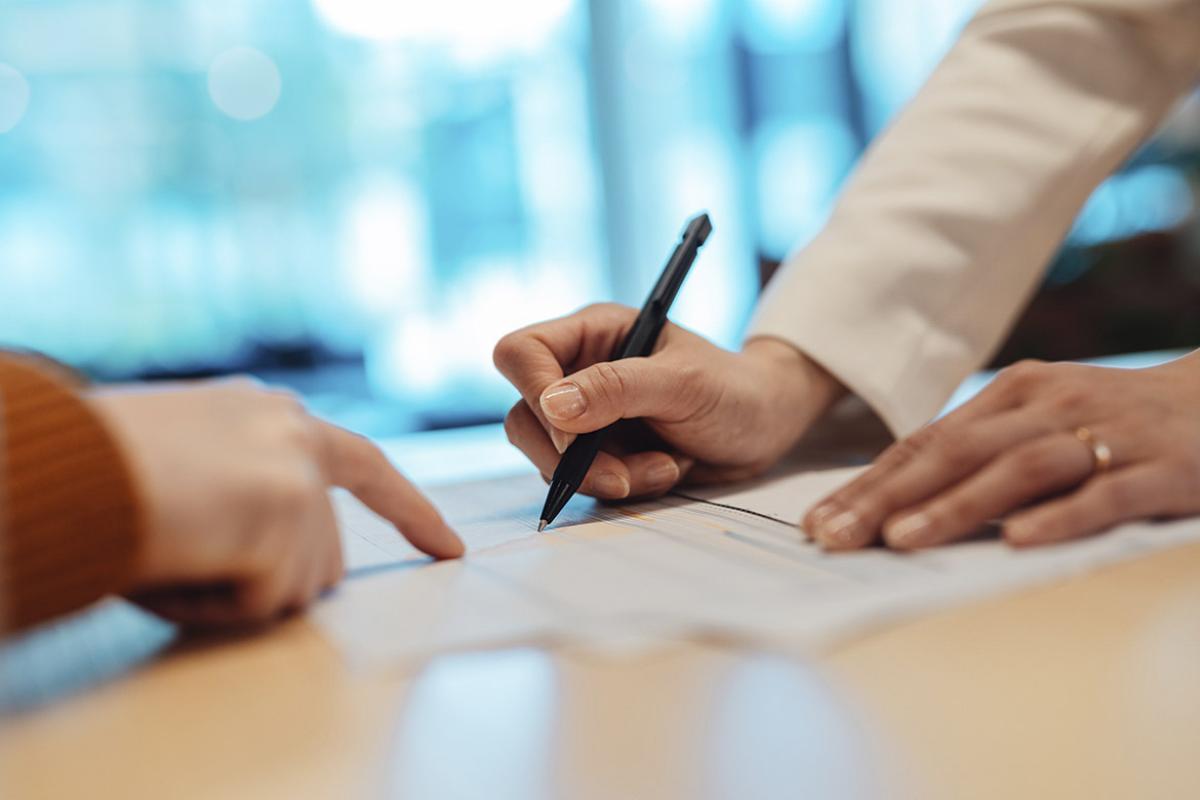 Hand signs a contract