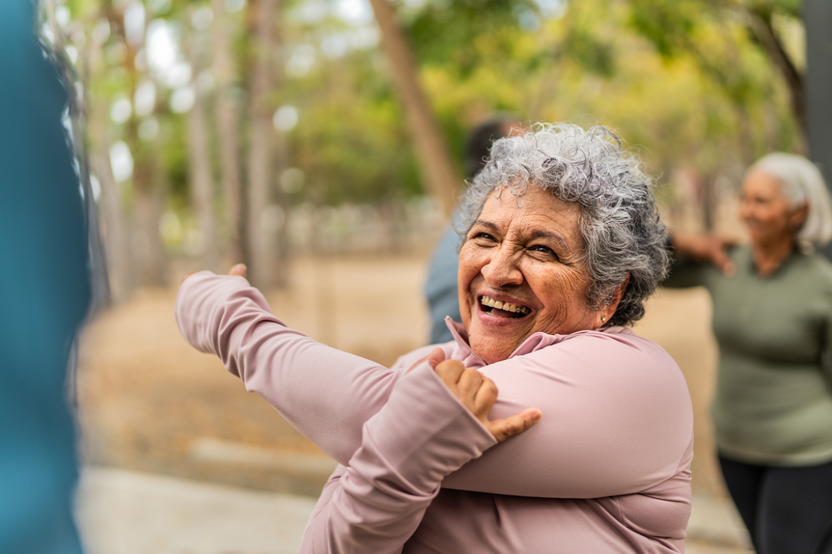Smiling woman stretches before a workout