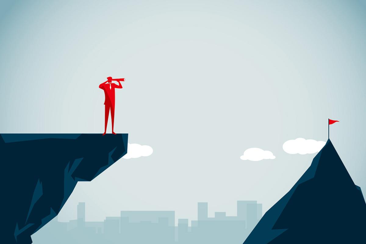 Figure looks through binoculars towards a mountain