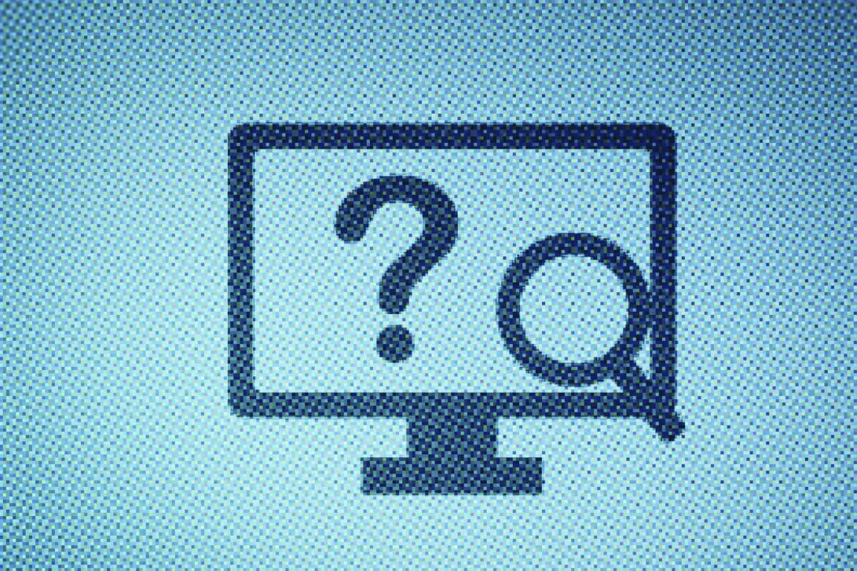 Computer screen with a question mark and magnifying glass