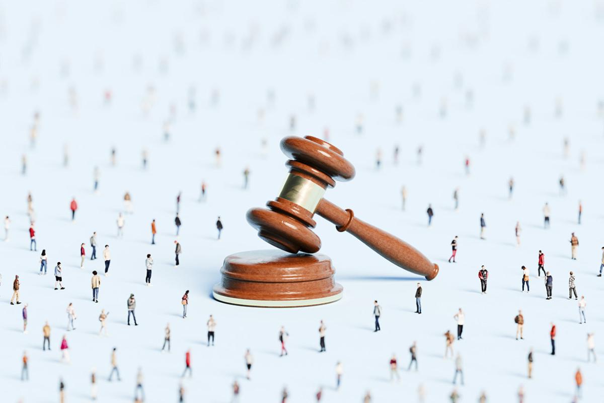 Giant gavel in a crowd of tiny figures