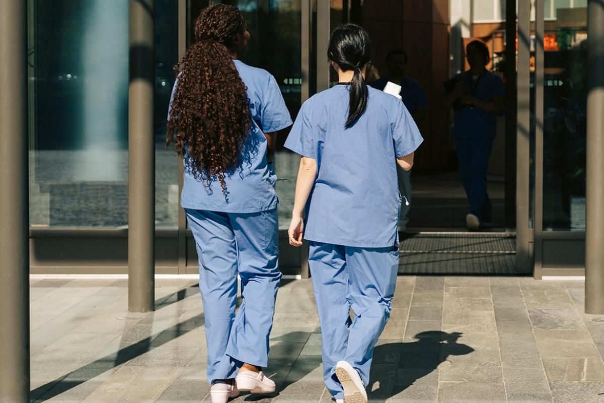 Physicians walking towards door of building