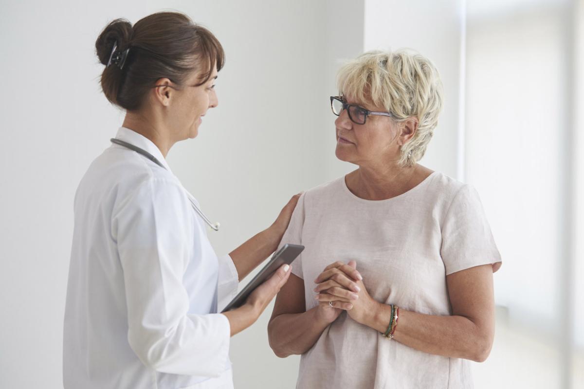 Physician places hand on patient's shoulder