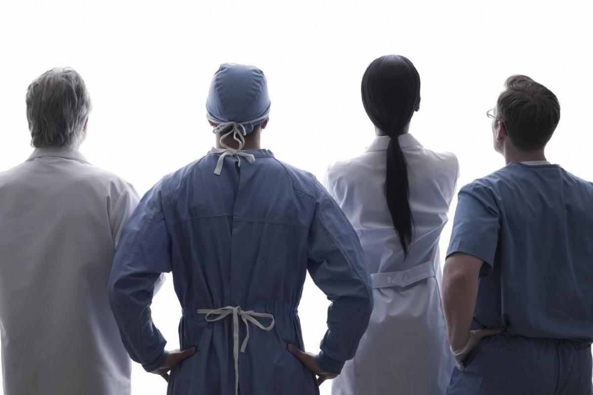 Four physicians stand in a row