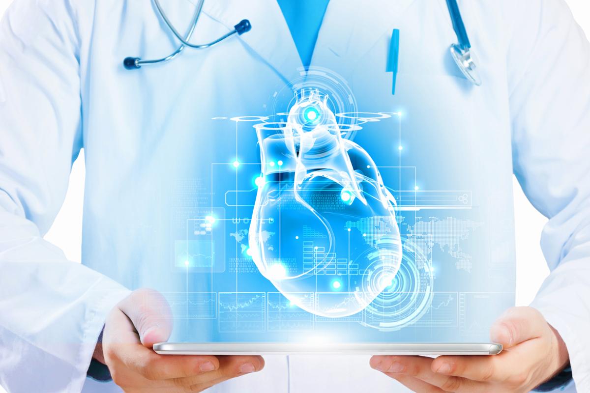 A physician in a white coat holds up a screen displaying computerized automation. 