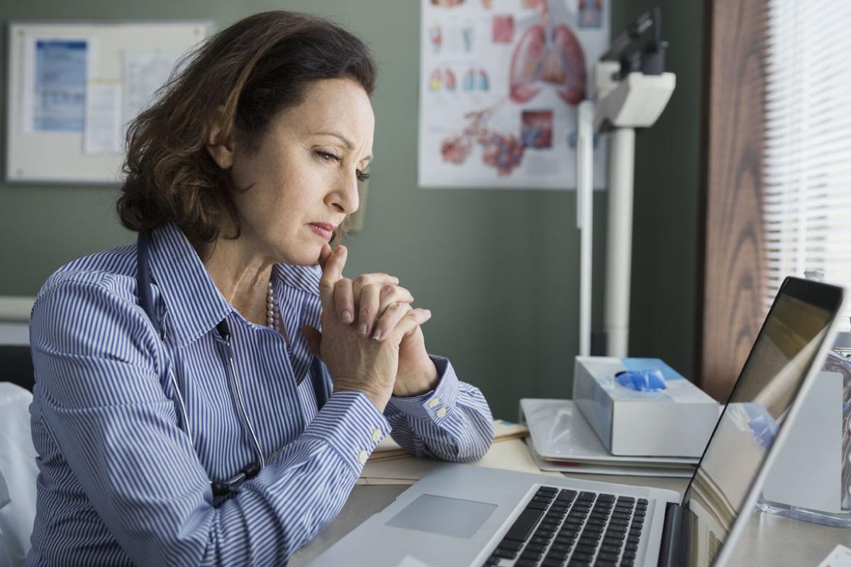 Woman watching a webinar on her computer.