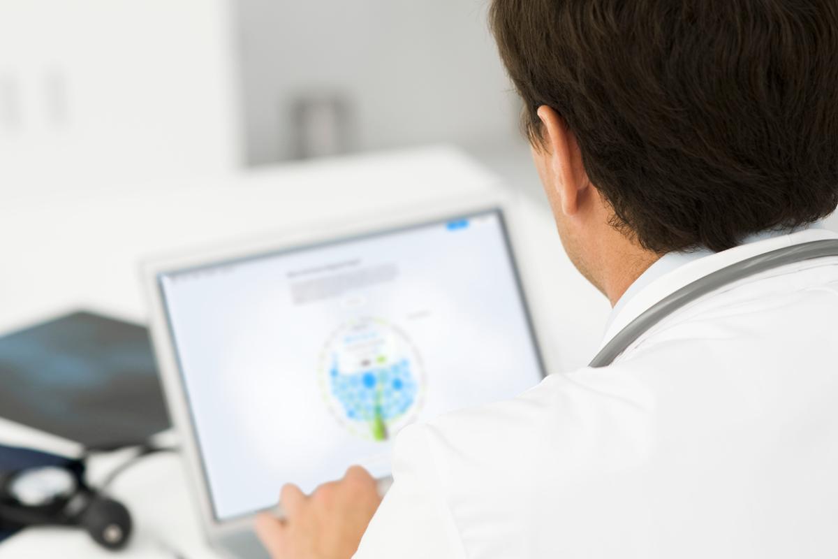 Physician doing research on a computer.